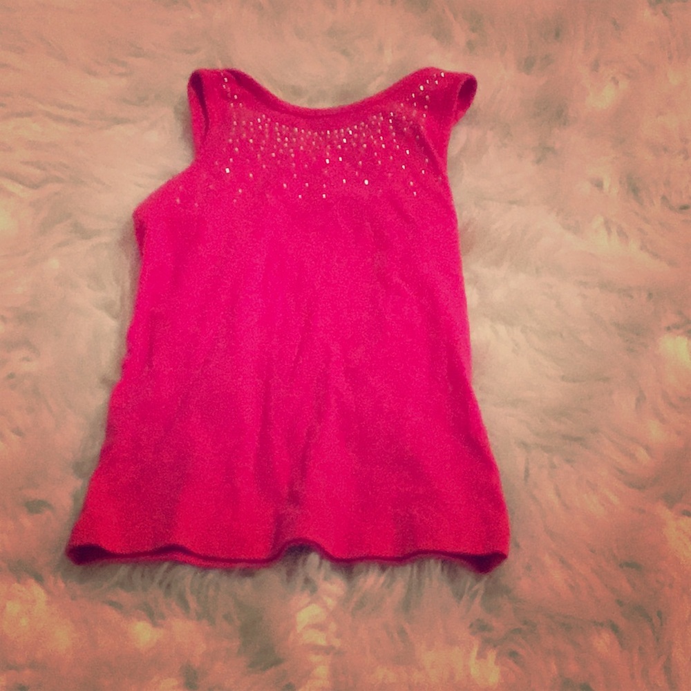 A badazzled pink tank top with a bow on the back